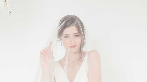 Bride wearing blusher veil over her face