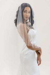 Bride wearing pearl beaded cathedral blusher veil. Alayna Pearl Cathedral Veil made in Canada by Laura Jayne Accessories Toronto.