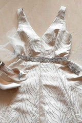 Flat lay of wedding dress with Amafi sash Angela Nuran shoes and face veil
