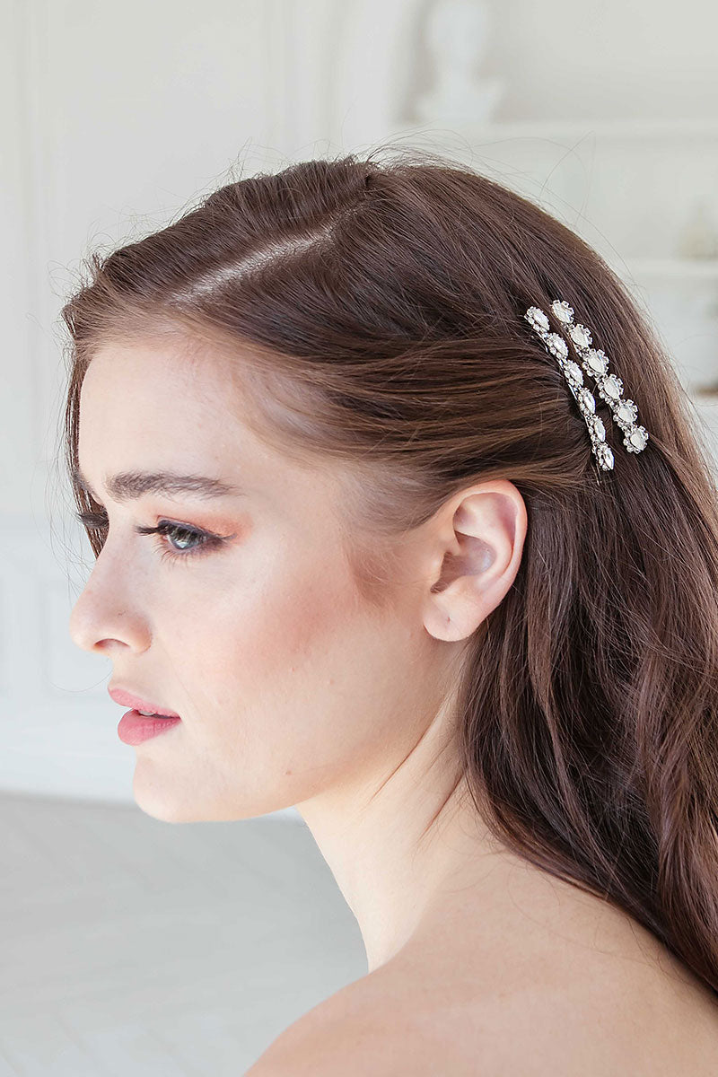 Profile of woman wearing crystal pear jewel barrettes