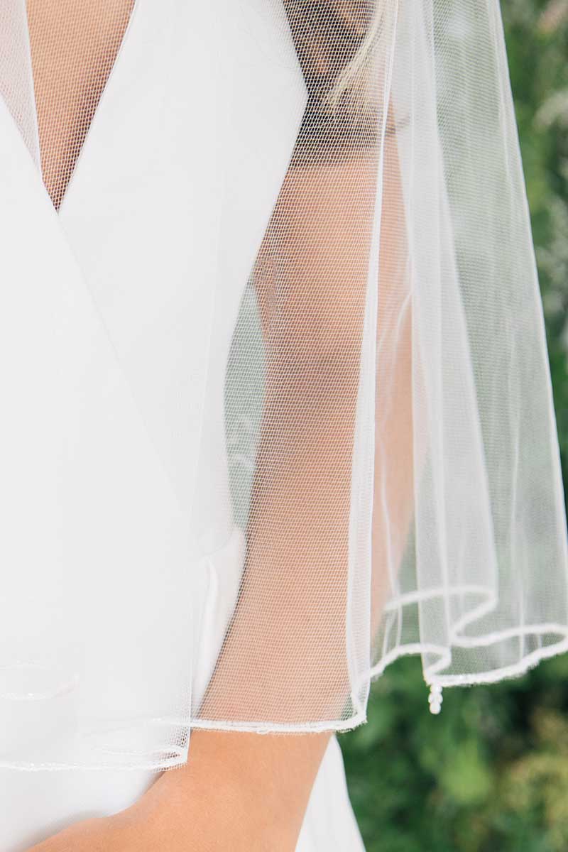 Detail close up of Laura Jayne Jess Beaded Edge Fingertip Bridal Veil