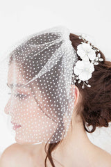 Profile of bride wearing Laura Jayne floral hair comb and dot face veil.