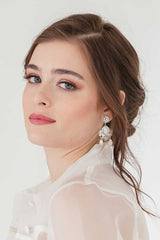 Woman wearing statement filigree crystal mother of pearl earrings