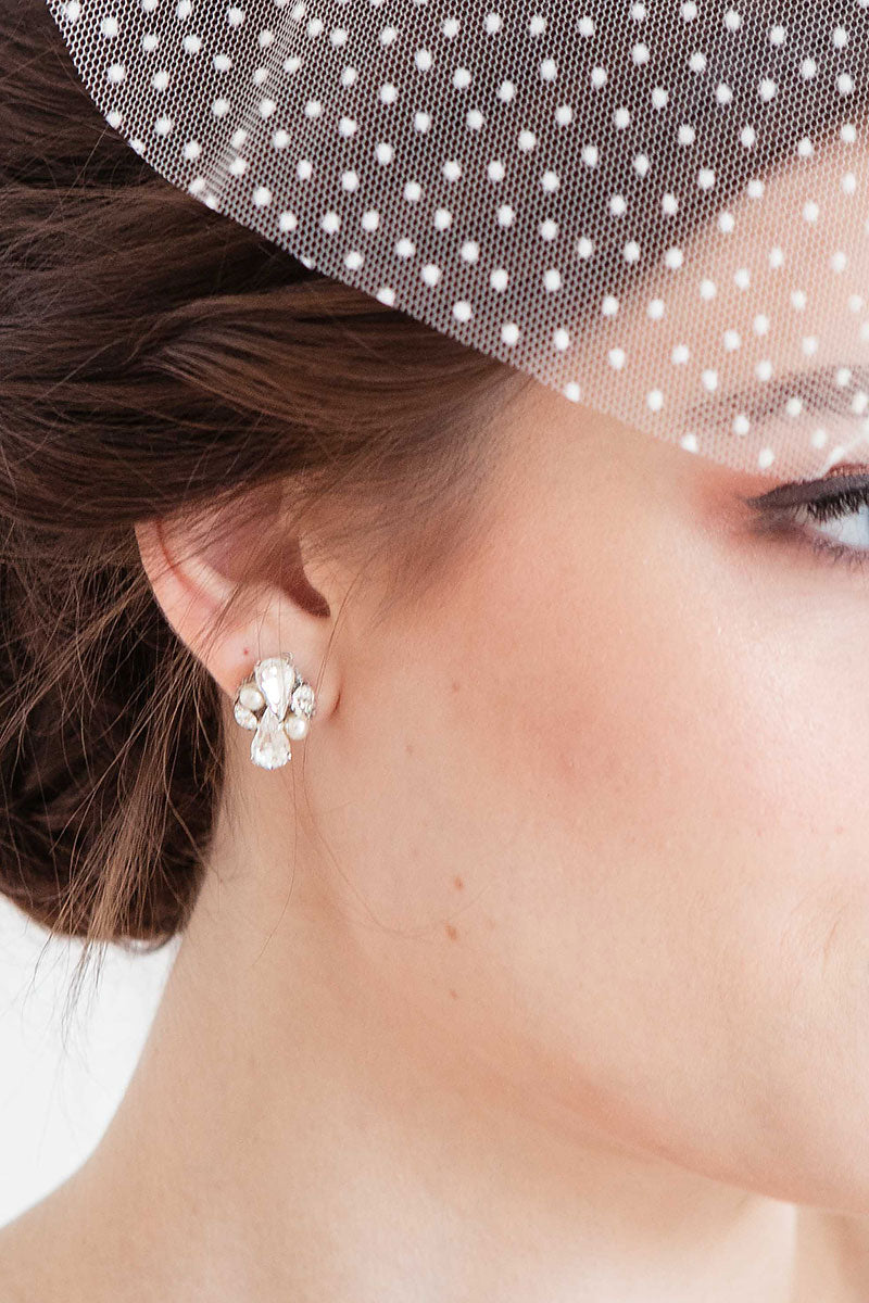 Closeup profile of bride wearing pear crystal and pearl post earrings.