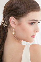 Profile of woman wearing pearl gold and champagne crystal bridal earrings.