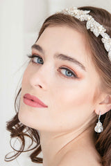 Woman wearing headband and pearl crystal drop earrings
