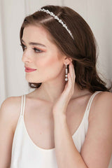 Long crystal dangle earrings for brides with a bit of edge. A row of three cone-shaped crystal spikes are joined by two pave crystal balls. Fun shimmer for any special occasion.