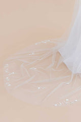 A close up view of the delicate hand-beaded blossom details found on the sides and train of the Monet Beaded Blossom Cathedral Veil from Laura Jayne Accessories Toronto. Handcrafted in Canada.