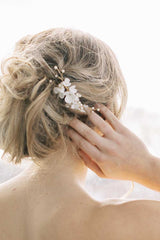 Back of woman's head wearing Laura Jayne Belinda clay flower comb with messy bun