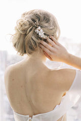 Backview of woman's head and shoulders wearing Laura Jayne Belinda clay flower comb