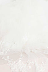 A close up view of Indra Cathedral Veil's hand embroidered floral details by Laura Jayne Accessories Toronto. Handcrafted in Canada.