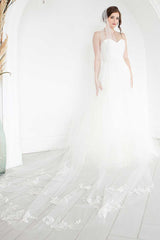 Full side front view of bride wearing hand embroidered floral Indra Cathedral veil including train.