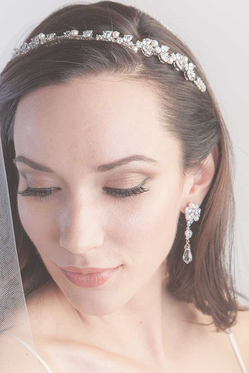 Woman with head down wearing Helena marquis CZ pearl headband by Laura Jayne Accessories