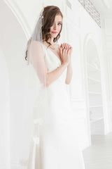 Side view of bride wearing waltz length veil with floral trim by Laura Jayne. Rosalie Mantilla Veil.
