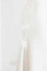 Close up view of hand embroidered flowers found at the sides of the Rosalie Mantilla Veil by Laura Jayne.