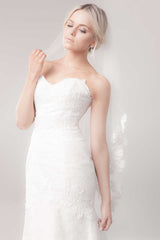 Side front of bride wearing Marlisa French Alencon lace fingertip length veil by Laura Jayne Accessories Toronto, Canada.