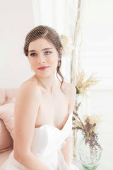 Modern contemporary bride wearing a timeless ivory colored birdcage veil by Laura Jayne. Manon Birdcage Veil. Handmade in Toronto, Canada.