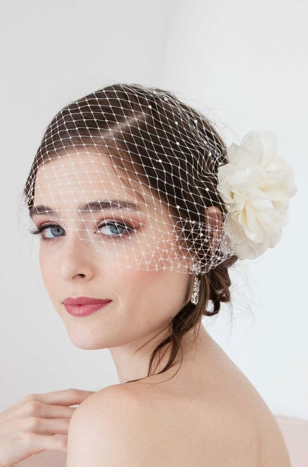 Trendy modern bride wearing a modern birdcage veil angled to one side of her head. Manon Birdcage Veil in ivory by Laura Jayne Accessories Toronto. Handmade in Canada.  