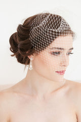 Modern minimalist bride wearing a Laura Jayne Manon Birdcage Veil with beautiful ivory netting over her face. Handcrafted in Toronto, Canada.