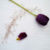 Delicate sprays of crystals and freshwater pearls extend over a 9 1/2" vine of rose gold. Clusters of pearls and crystals add additional sparkle. Wear as a headband of a back piece.