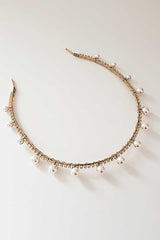 Closeup image of skinny headband with pearls and crystals. Syrena Graduated Pearl Headband by Laura Jayne. Handcrafted in Toronto, Canada.