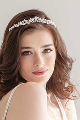 Closeup view of chic modern bride wearing a crystal and pearl bridal tiara. Kelly Tiara by Laura Jayne. Handcrafted in Toronto, Canada.