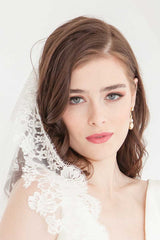 Close up of bride wearing Peyton cathedral length mantilla wedding veil.