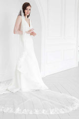 Off center view of the Peyton Mantilla Cathedral Veil's full train on bride.