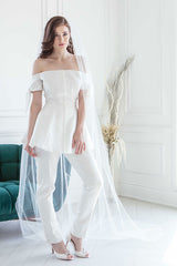 Cool contemporary bride wearing unique Winona Cathedral Veil with Feathers paired with a modern bridal pantsuit. Veil also works with a sleek gown. Made in Canada by Laura Jayne Accessories Toronto.