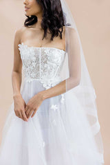 Side profile of bride wearing cathedral veil by Laura Jayne. Heather cathedral length veil with horsehair trim