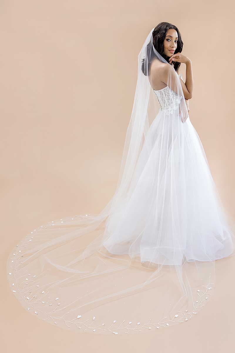 Profile of bride wearing Laura Jayne's classic yet whimsical Liliya Cathedral Veil with shimmering paillettes
