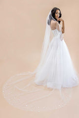 Profile of bride wearing Laura Jayne's classic yet whimsical Liliya Cathedral Veil with shimmering paillettes