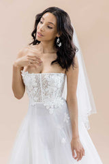 Bride wearing Jess fingertip circle cut beaded edge veil with pearl and crystal droplets by Laura Jayne Accessories. Handcrafted in Canada.