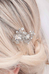 Sparkling and whimsical this bridal comb feature filigree blossoms and vines accented with crystal stones and pearls. Finished on a wire tooth metal comb.