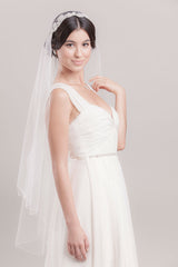 Full view of a modern romantic bride wearing the hand embroidered floral fingertip length Juliet veil by Laura Jayne Accessories. Made in Toronto, Canada.