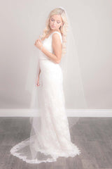 Modern minimalist bride wearing a blush pink chapel length bridal veil with French lace floral trim. Bree Chapel Length Chantilly Lace Veil by Laura Jayne Accessories Toronto. Made in Canada.