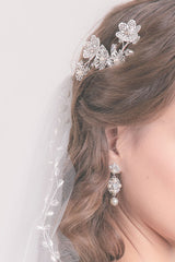 woman wearing haircomb and pearl drop earring