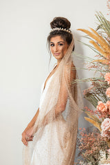 Profile of woman wearing glitter cowl cathedral veil. Available in ivory or rose gold color from Laura Jayne Accessories Toronto. Made in Canada.