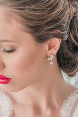 Profile of woman wearing gold leaf crystal pearl drop wedding earrings by Laura Jayne