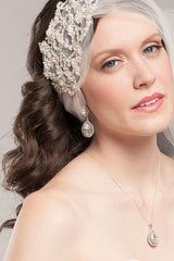 Woman wearing a bridal necklace with a teardrop shape and crystal halo bezel by Laura Jayne Accessories