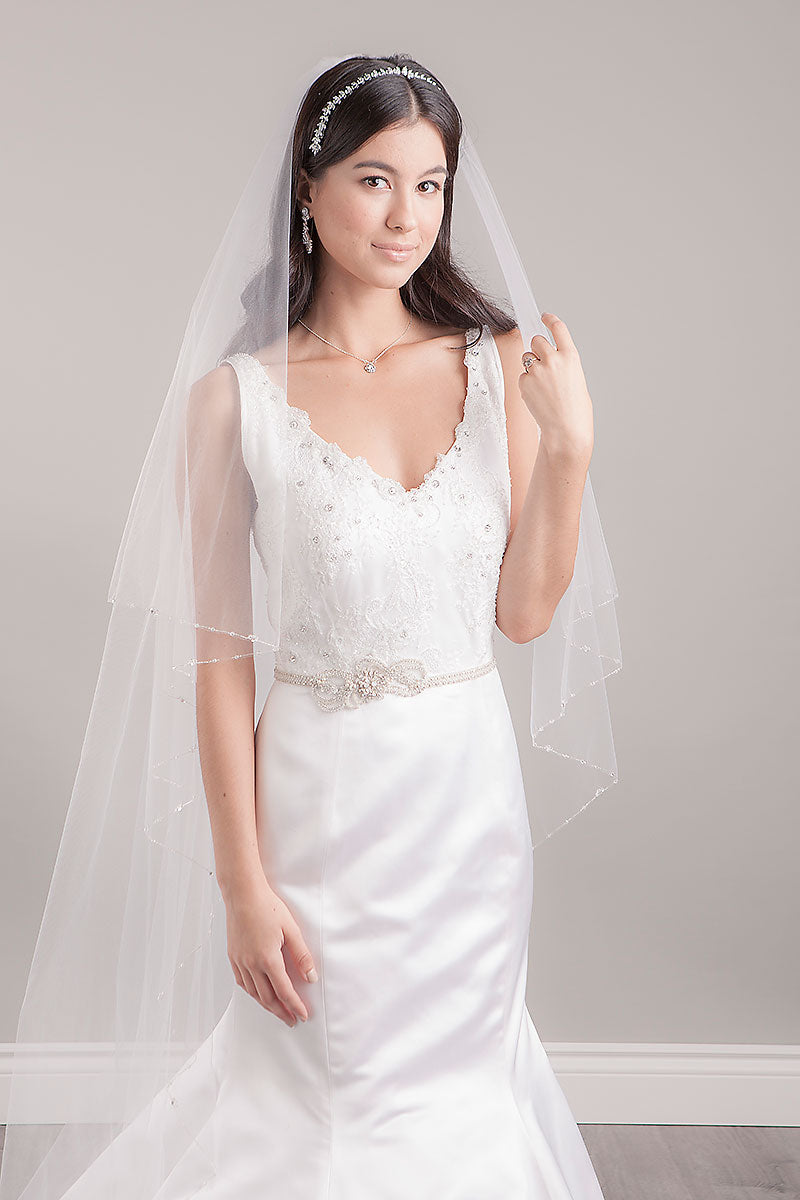 Portrait of bride wearing long veil and Lourdes bridal sash by Laura Jayne Accessories