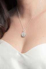 woman's neckline with cystal pendant