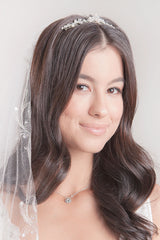 Bride wearing pearl and crystal tiara bridal comb. Audree Tiara Bridal Comb. Made in Toronto, Canada by Laura Jayne Accessories.