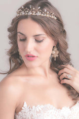 Head and shoulders of woman wearing vine bridal tiara