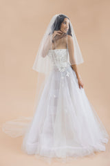 Portrait of bride wearing cathedral bridal veil with blusher Rosalynda by Laura Jayne