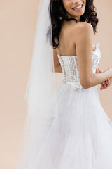 profile of bride smiling wearing Rosalynda cathedral pencil edge veil by Laura Jayne