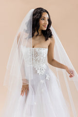 Bride wearing two-tier cathedral veil with blusher