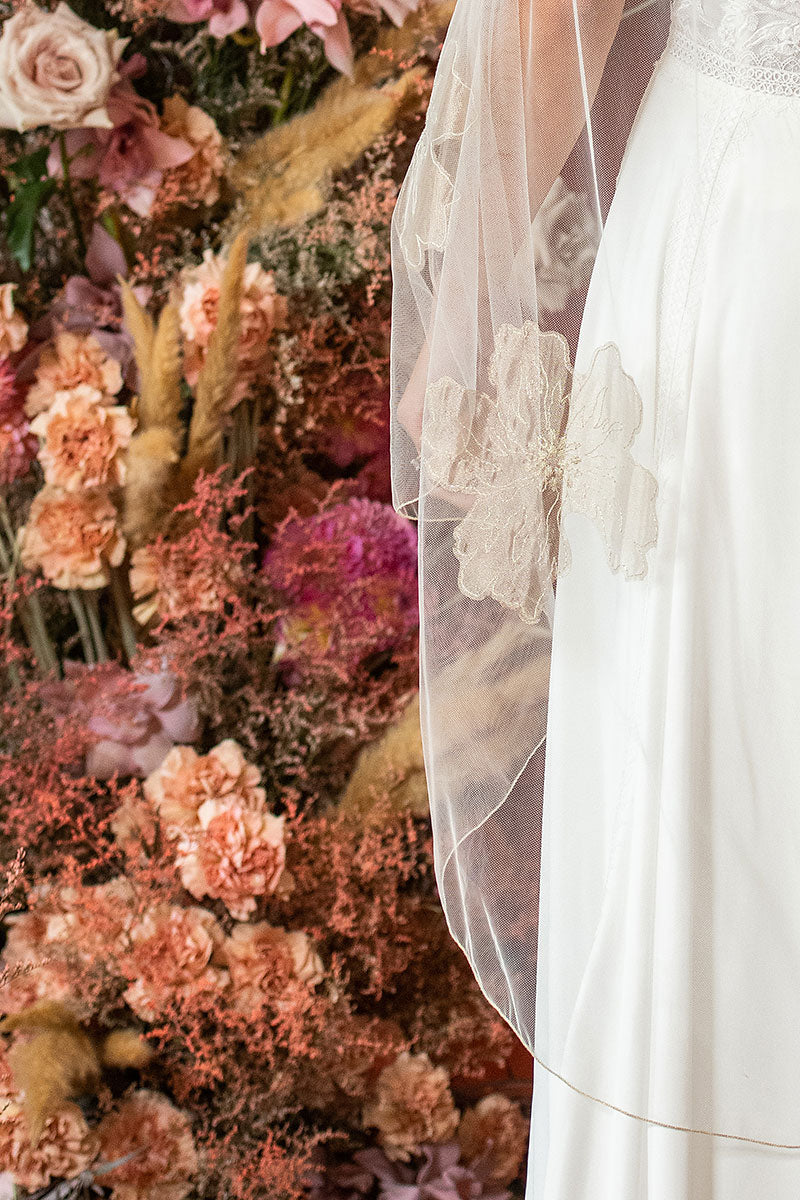 Close up view of tropical inspired floral blooms embroidered on Isla Gold Floral Waltz Wedding Veil. Handcrafted in Canada by Laura Jayne Accessories Toronto.