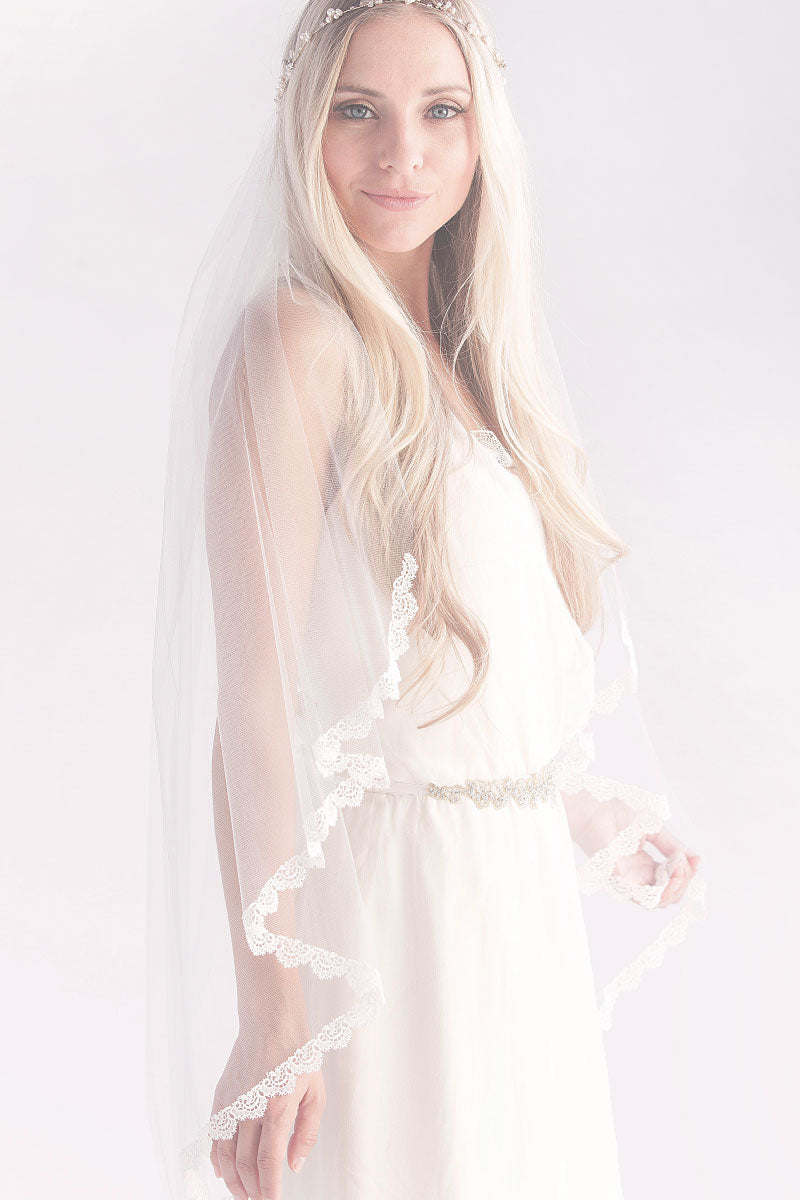 Profile of bohemian bride wearing Julia fingertip veil with Venise lace trim by Laura Jayne Toronto. Handcrafted in Canada.
