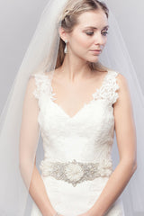 Modern minimalist bride wearing a simple sheer oval cut fingertip length wedding veil. Annastacia Fingertip Veil by Laura Jayne Accessories Toronto. Handcrafted in Canada.